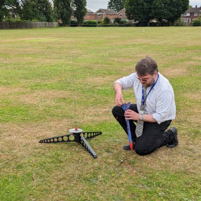 Science technician preparing rocket for launch